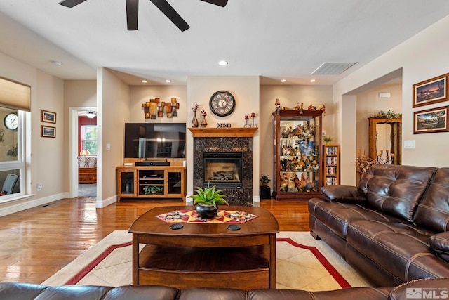 living room with visible vents, wood finished floors, a fireplace, recessed lighting, and a ceiling fan