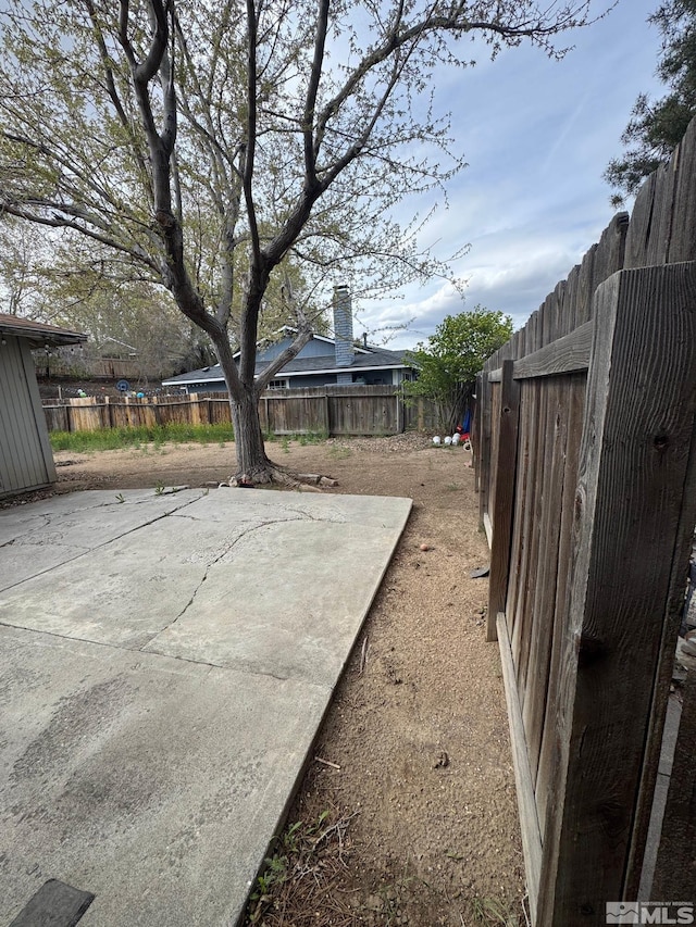view of yard with a fenced backyard and a patio area
