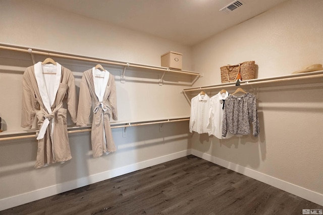 walk in closet featuring visible vents and dark wood-style floors