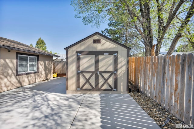 view of shed with a fenced backyard