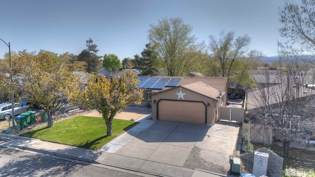 view of front of home featuring an attached garage, stucco siding, a front yard, roof mounted solar panels, and driveway