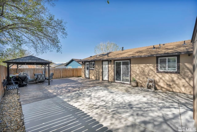view of patio / terrace with a gazebo and a fenced backyard