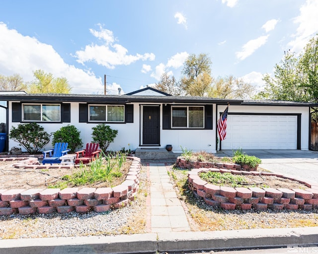 ranch-style house with a garage and concrete driveway