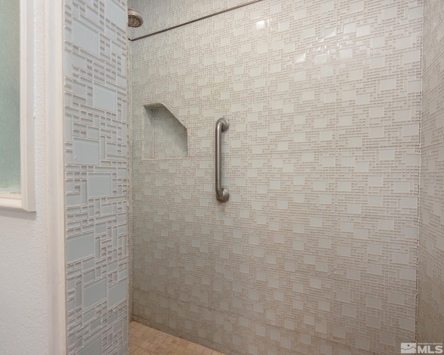 interior details with a tile shower
