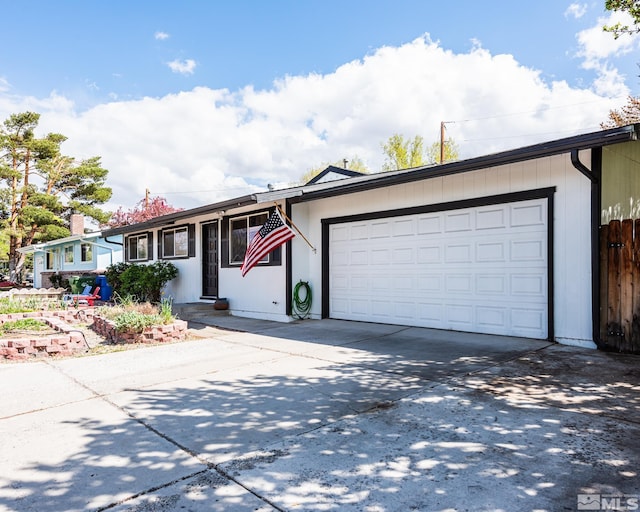 ranch-style house with an attached garage and driveway
