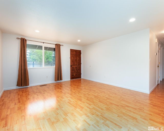 spare room featuring recessed lighting, baseboards, visible vents, and light wood-style floors