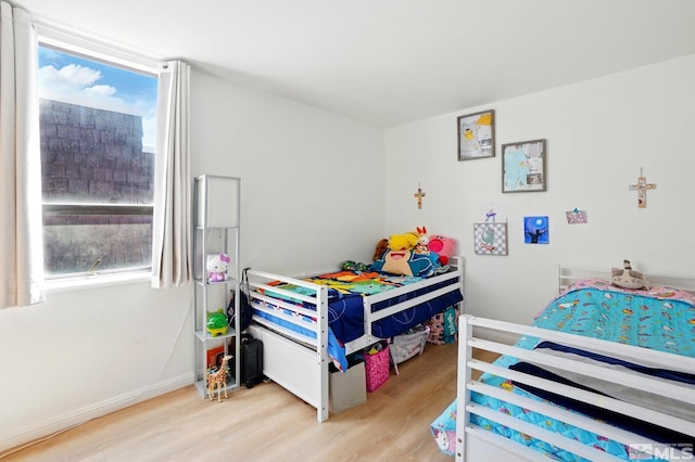 bedroom with baseboards and light wood-style flooring
