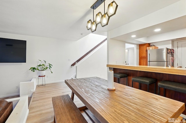 dining room with stairway, baseboards, light wood-style floors, and recessed lighting
