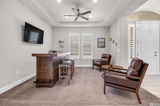 interior space featuring recessed lighting, a ceiling fan, baseboards, and light colored carpet