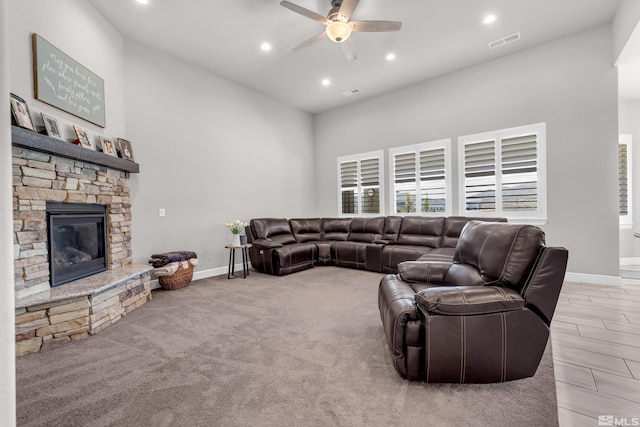living area with baseboards, ceiling fan, a fireplace, and recessed lighting
