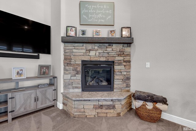 living room featuring carpet floors, baseboards, and a fireplace