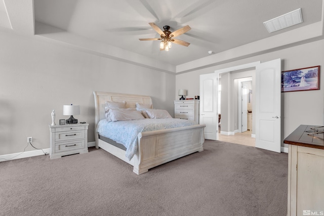 carpeted bedroom featuring visible vents, baseboards, and ceiling fan