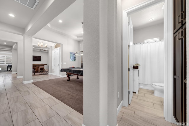 hallway featuring baseboards, a notable chandelier, recessed lighting, and visible vents