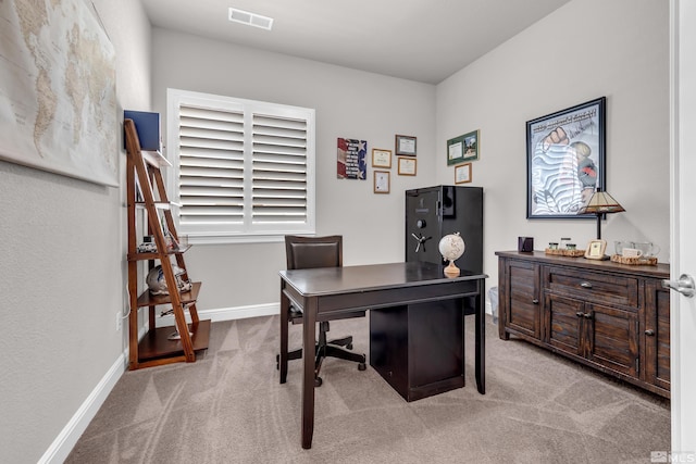carpeted office space featuring baseboards and visible vents