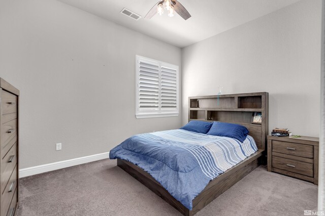 carpeted bedroom featuring a ceiling fan, baseboards, and visible vents