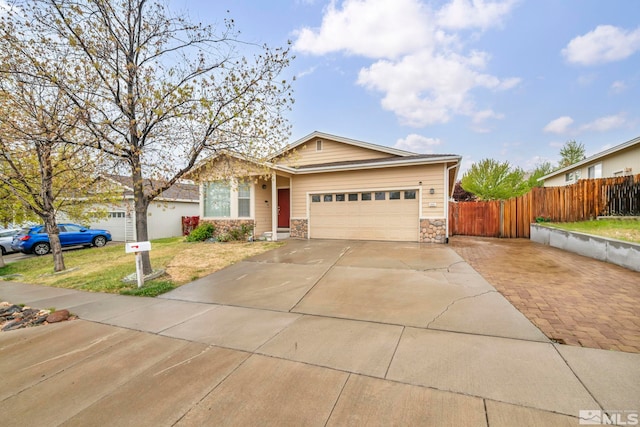 ranch-style home featuring a front lawn, fence, stone siding, an attached garage, and driveway