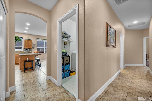 hall featuring recessed lighting, baseboards, visible vents, and light tile patterned floors