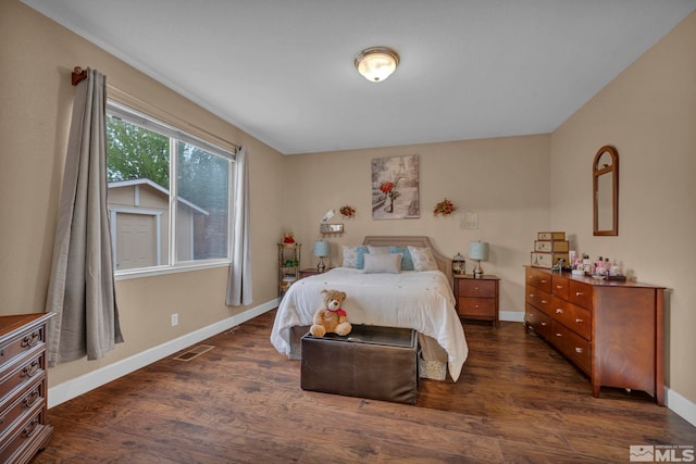 bedroom featuring baseboards, dark wood-style floors, and visible vents