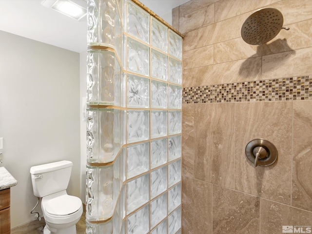 full bathroom featuring vanity, walk in shower, and toilet