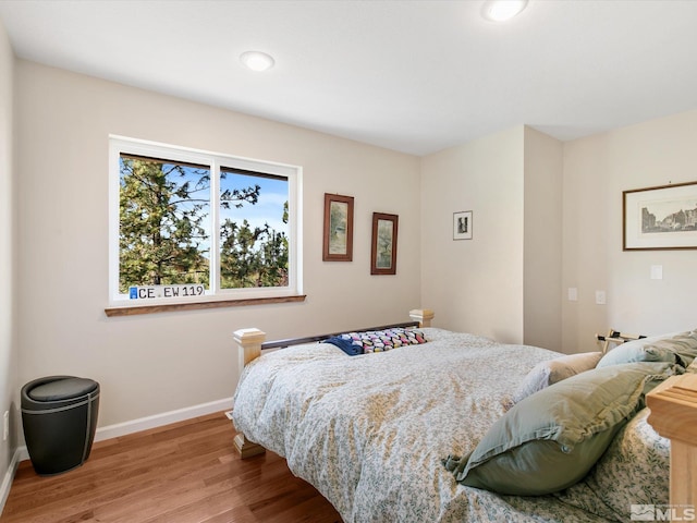 bedroom with recessed lighting, baseboards, and light wood finished floors