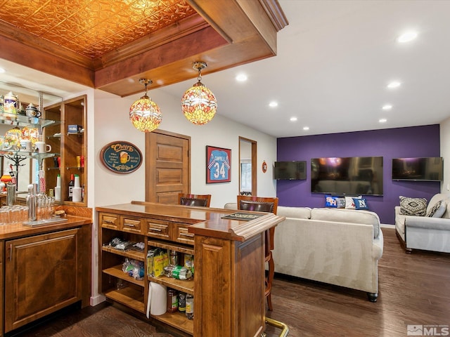 bar with dark wood-style flooring, wet bar, pendant lighting, an ornate ceiling, and recessed lighting