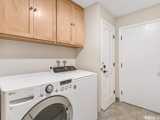 clothes washing area featuring cabinet space and independent washer and dryer