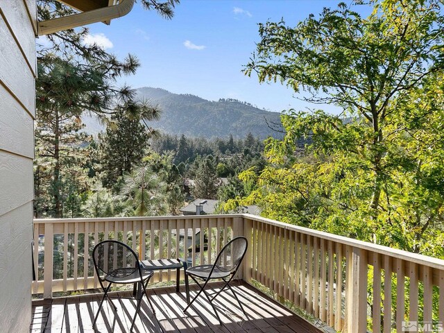 balcony with a mountain view and a wooded view