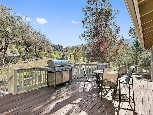 wooden deck featuring outdoor dining area and area for grilling