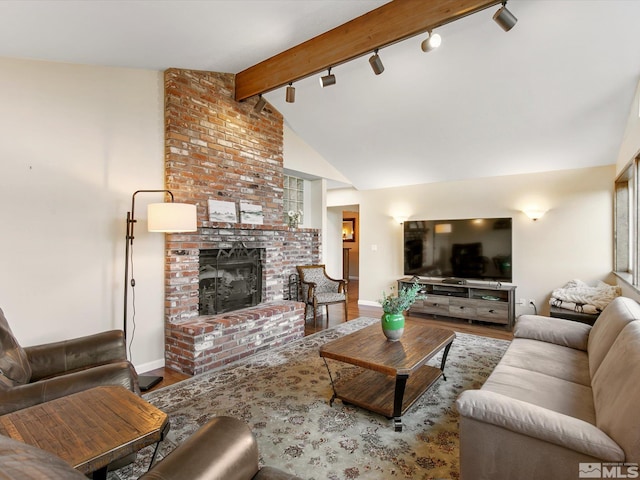 living room with vaulted ceiling with beams, rail lighting, baseboards, and wood finished floors