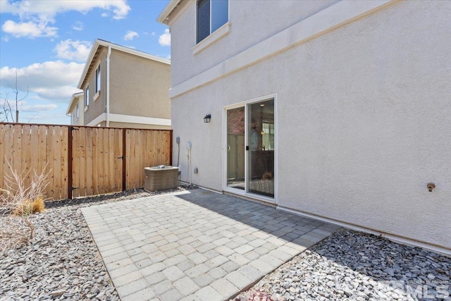 view of patio / terrace featuring fence and central AC unit