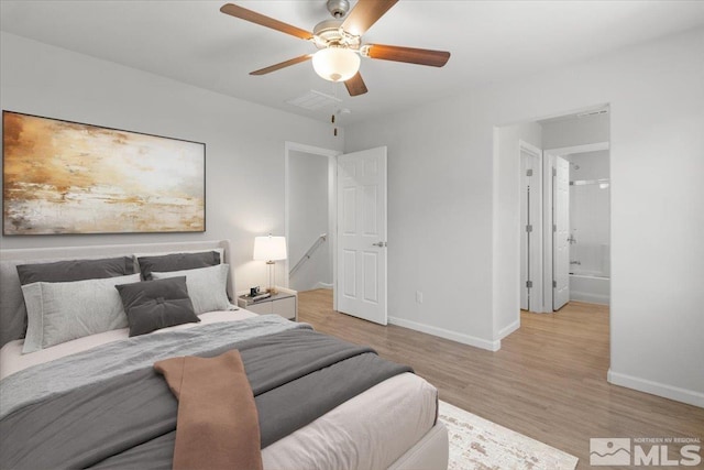 bedroom with ceiling fan, baseboards, visible vents, and wood finished floors