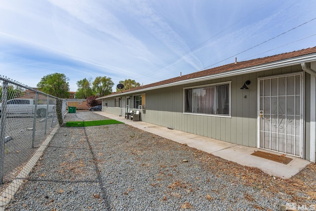view of side of home with a patio and fence private yard