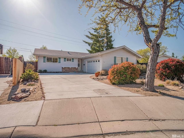 single story home with a garage, fence, and concrete driveway