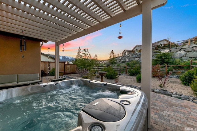 view of swimming pool featuring a hot tub, a pergola, and a fenced backyard