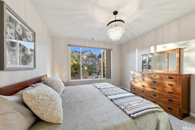 bedroom featuring a notable chandelier, visible vents, baseboards, and carpet
