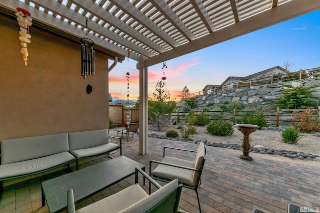view of patio with an outdoor living space, a fenced backyard, and a pergola