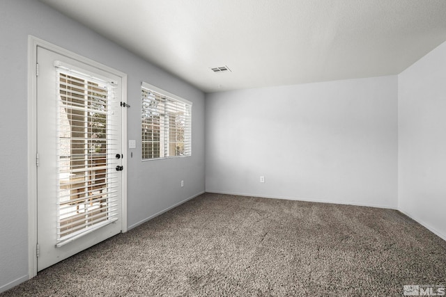 carpeted empty room with baseboards and visible vents