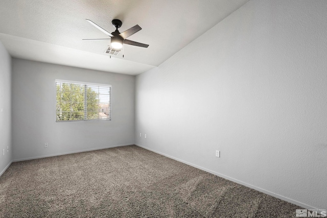 empty room featuring baseboards, ceiling fan, and carpet flooring