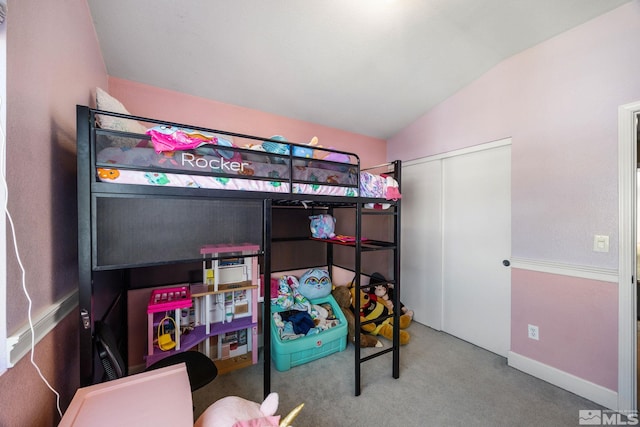 carpeted bedroom with a closet and lofted ceiling