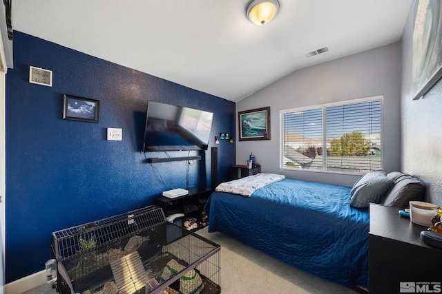 carpeted bedroom with multiple windows, lofted ceiling, a textured wall, and visible vents