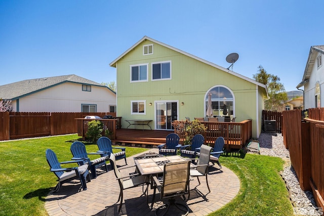 rear view of house featuring a fenced backyard, a patio area, a yard, and a deck