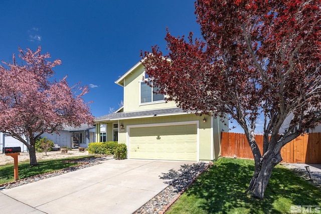 view of property hidden behind natural elements with a front lawn, fence, stucco siding, concrete driveway, and an attached garage