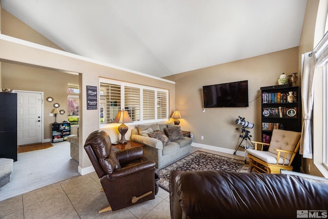 living room featuring tile patterned floors, baseboards, and lofted ceiling