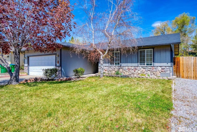 single story home with a front yard, fence, stone siding, and a garage