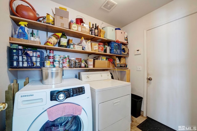 laundry area featuring separate washer and dryer, laundry area, and visible vents