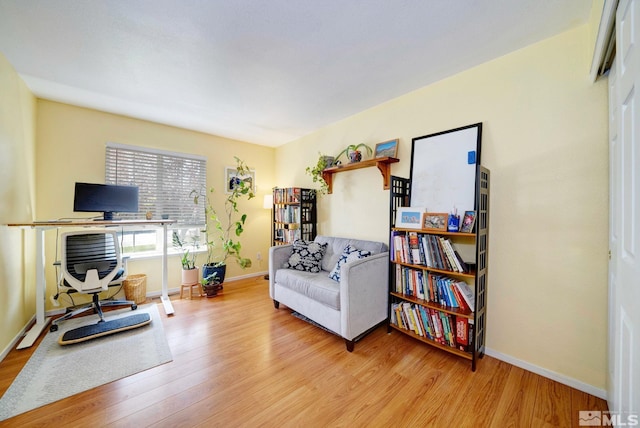 living area with baseboards and light wood-style flooring