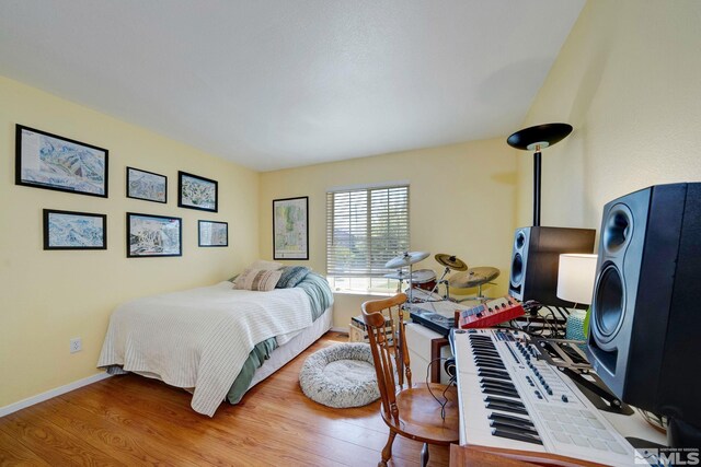 bedroom featuring baseboards and wood finished floors