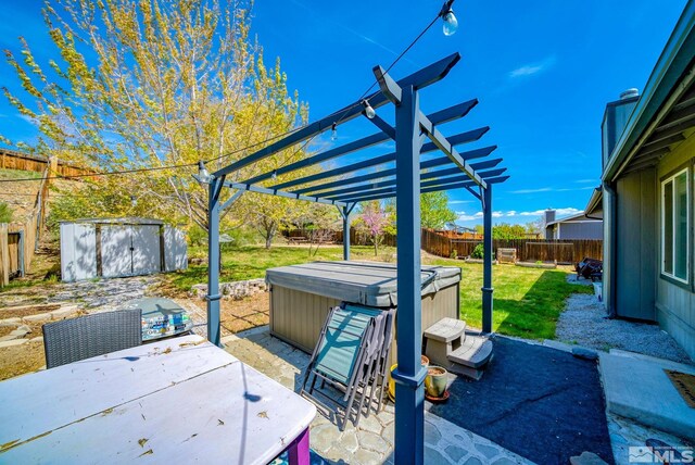 view of patio with a pergola, a hot tub, a storage shed, a fenced backyard, and an outbuilding