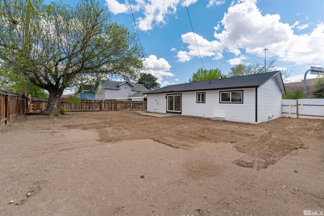 back of property featuring a fenced backyard