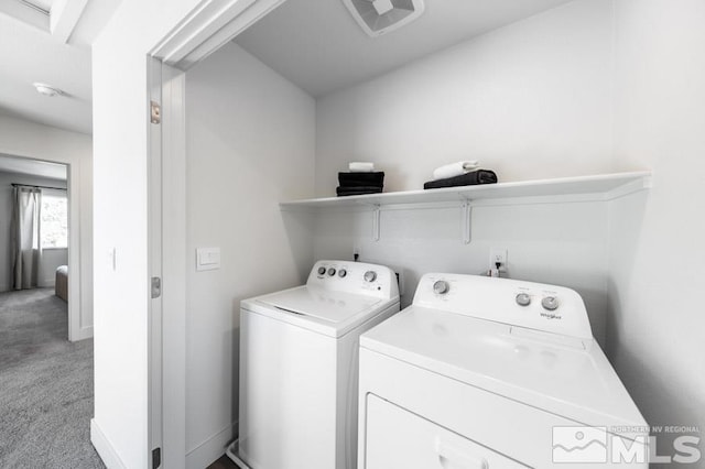 laundry area featuring separate washer and dryer, laundry area, and light colored carpet